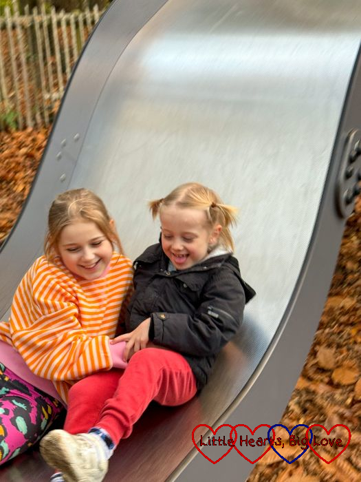 Sophie and Thomas going down a slide together