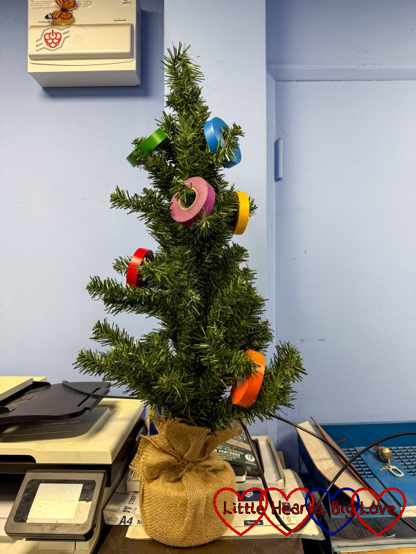 A mini Christmas tree decorated with rolls of spark tape