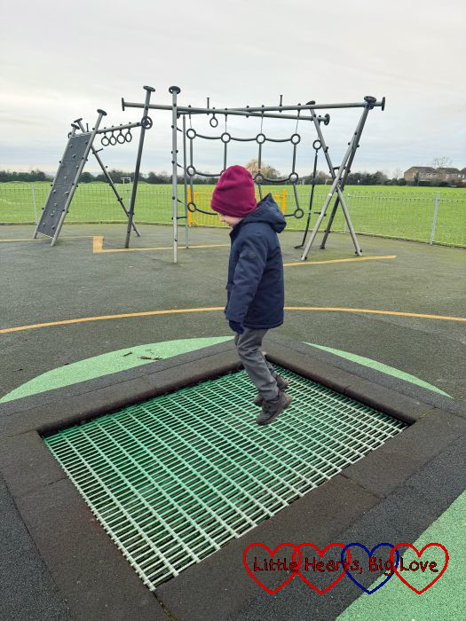 Thomas bouncing on a trampoline at the park