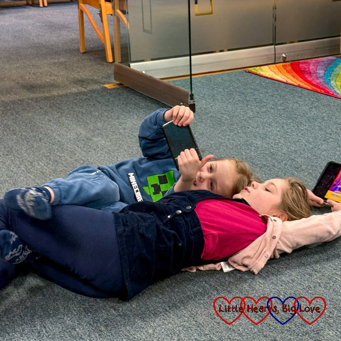 Sophie and Thomas snuggled up together on the floor at church