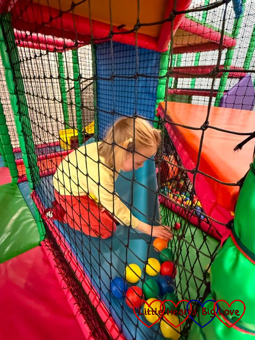 Thomas playing with balls at soft play