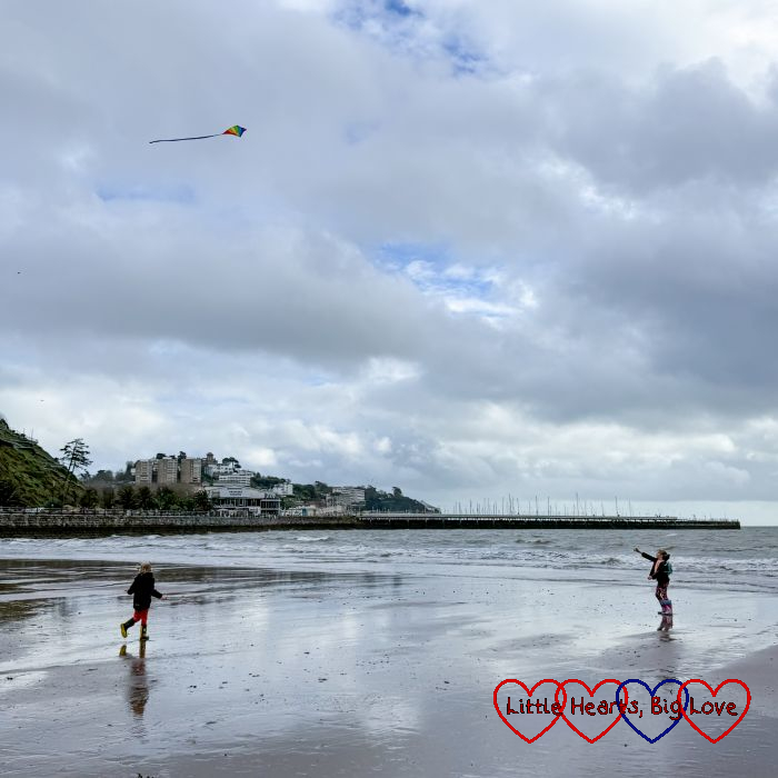 Sophie flying a kite on the beach