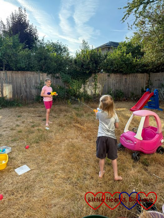 Sophie and Thomas having a water fight