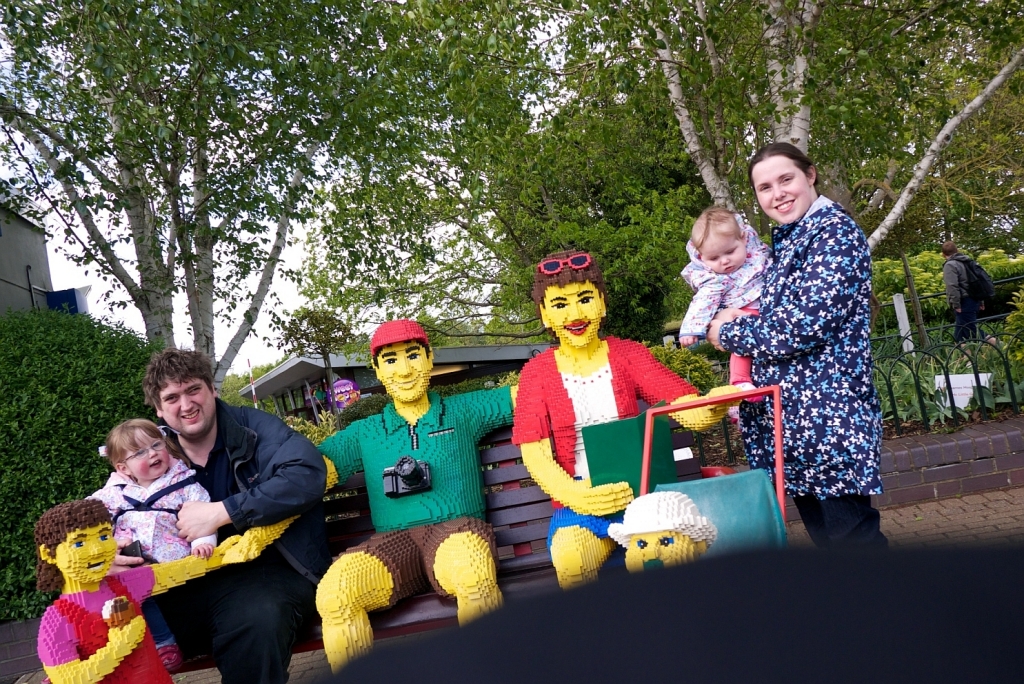 A slightly wonky shot of hubby, Jessica, me and Sophie sitting with some Lego people at Legoland
