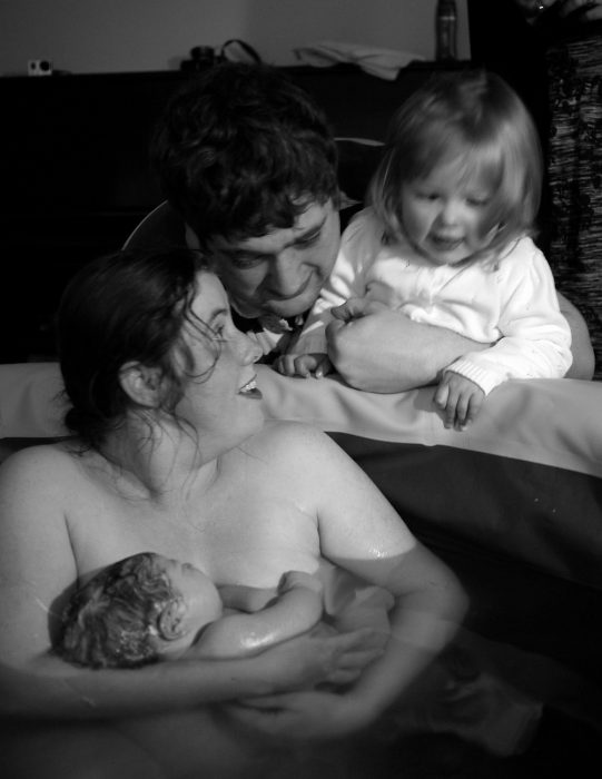 When Jessica met Sophie - me holding Sophie in the birth pool while hubby and Jessica look on