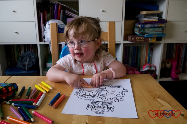 Jessica colouring in the picture of her and Peppa Pig