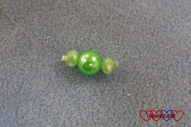 Three beads on beading to make a necklace