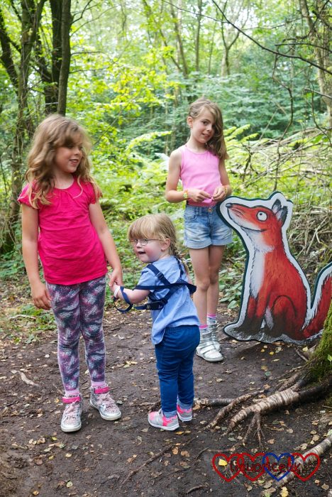 Jessica with her cousins standing by the fox on the Gruffalo trail at Alice Holt Forest