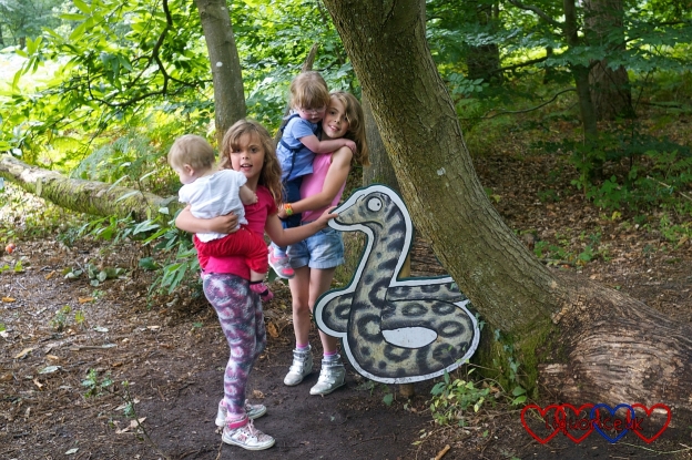 Jessica and Sophie with their cousins standing by the Snake on the Gruffalo trail at Alice Holt Forest