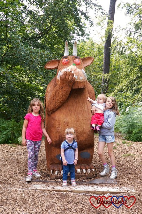Jessica and Sophie with their cousins, standing next to the Gruffalo sculpture at Alice Holt forest
