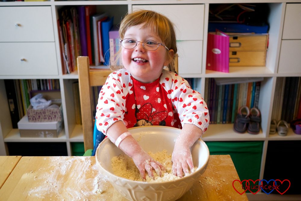 Jessica helping to mix scones with her fingers