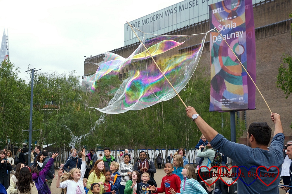 Children popping giant bubbles outside the Tate Modern - Silent Sunday 31/05/15 - Little Hearts, Big Love