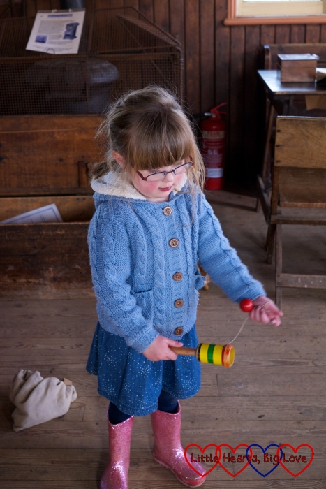 Playing cup and ball - Easter fun at Chiltern Open Air Museum - Little Hearts, Big Love