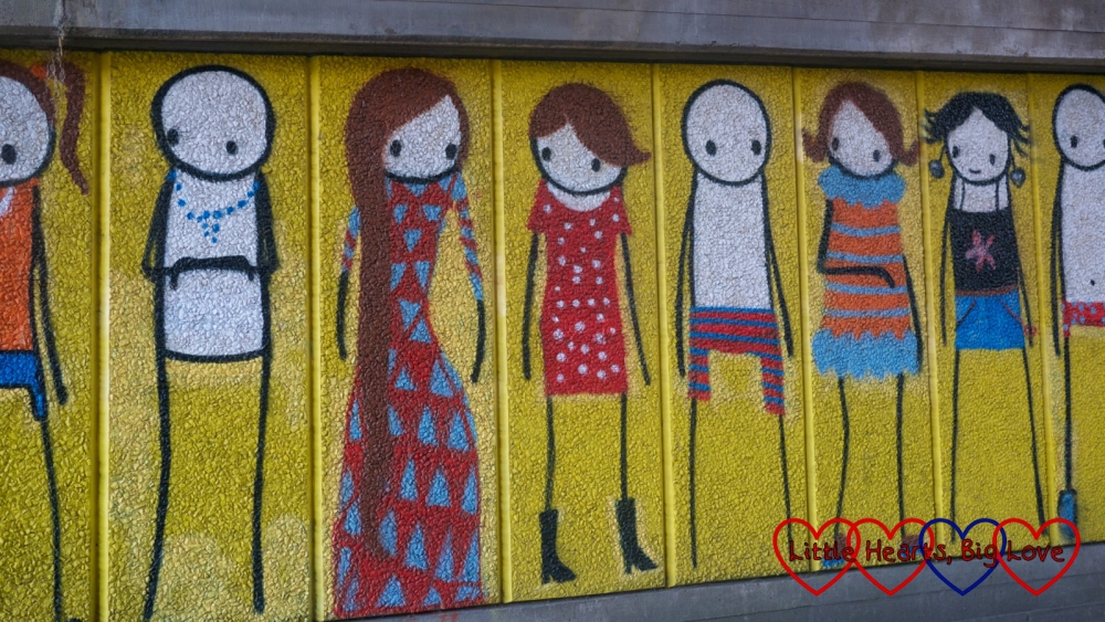 A street art mural showing lots of different people