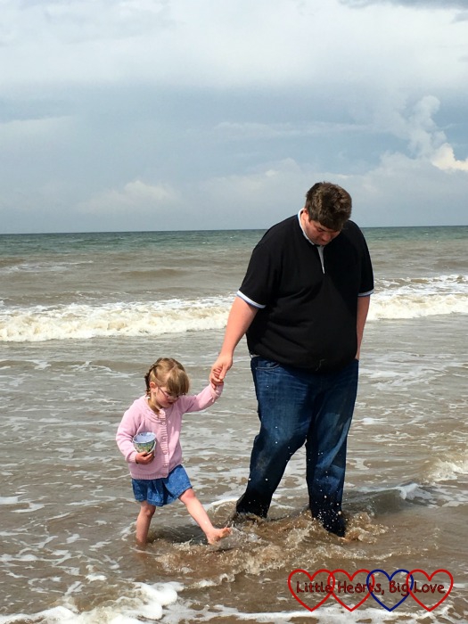 My big girl paddling in the sea with her daddy