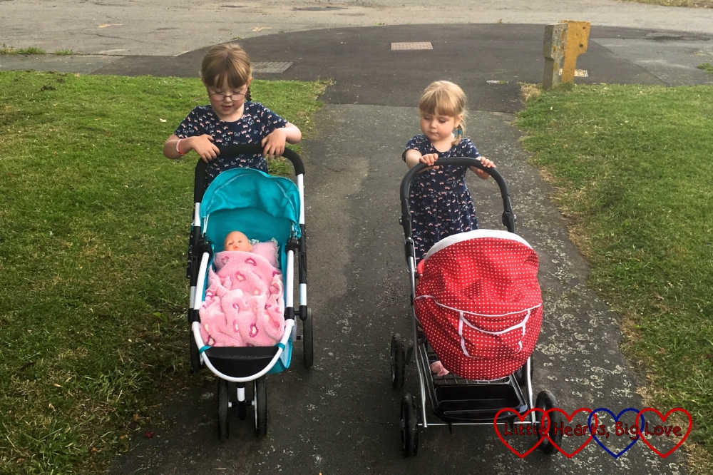 Jessica and Sophie taking their dolls prams out for a walk