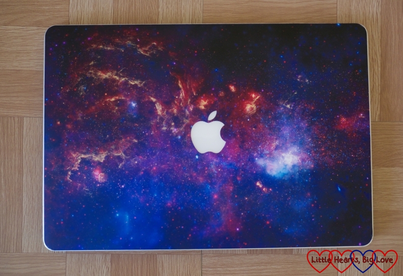 The CaseApp Crazy Galaxy skin on hubby's MacBook Pro