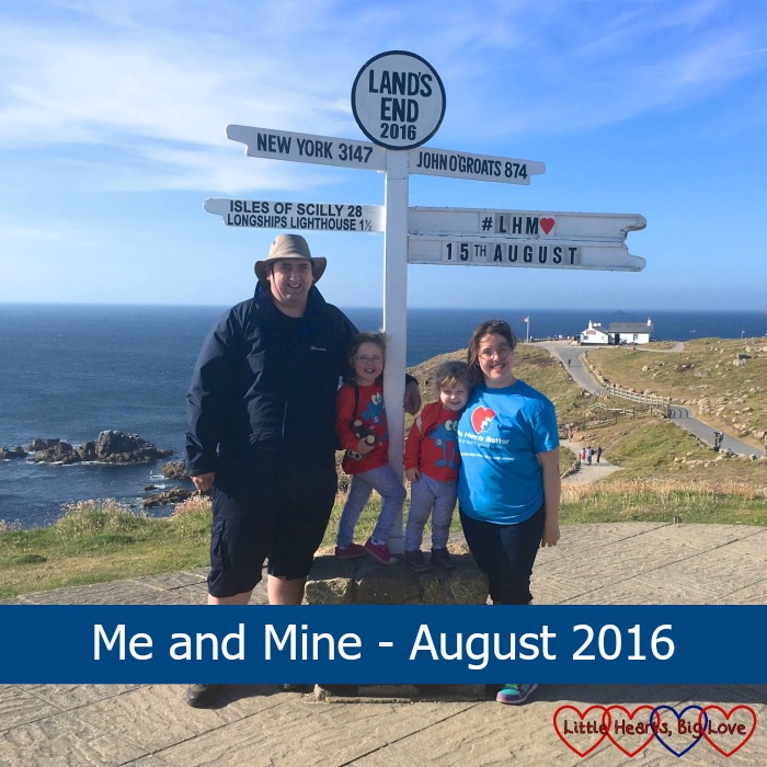 Me, hubby, Jessica and Sophie standing at the Land's End signpost with the text "Me and Mine - August 2016"