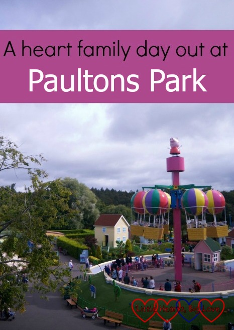 Looking across at Peppa's Big Balloon Ride in Peppa Pig World with the text "A heart family day out at Paultons Park"