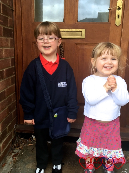 Jessica in her Girls' Brigade uniform and Sophie in a white top and pink spotty skirt with her hands clasped together
