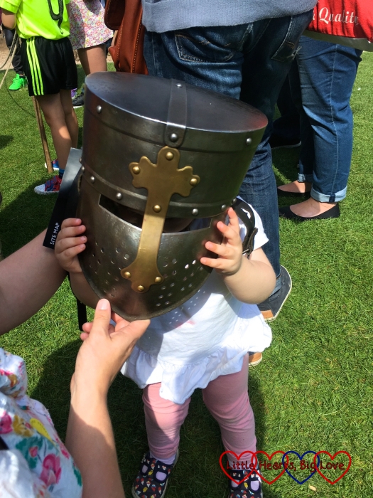 Sophie tries on the knight's helmet