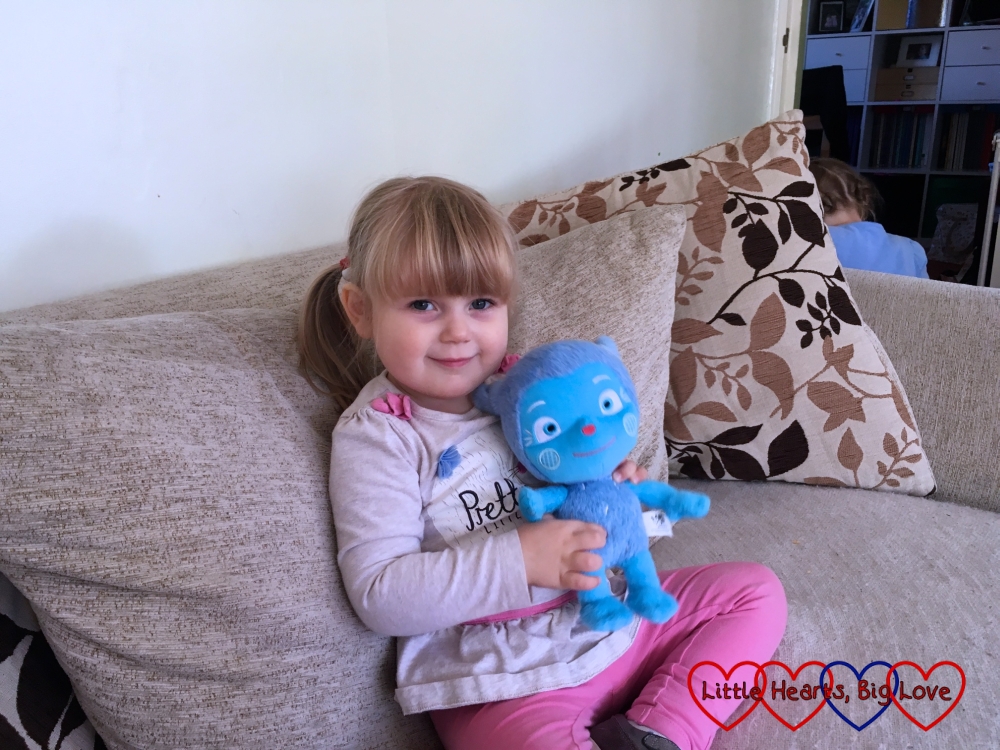 Sophie sitting on the sofa holding Messy Monster