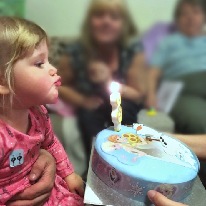 Sophie blowing out the candle on her birthday cake