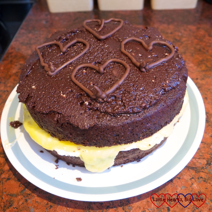A chocolate layer cake with a passionfruit curd and cream filling