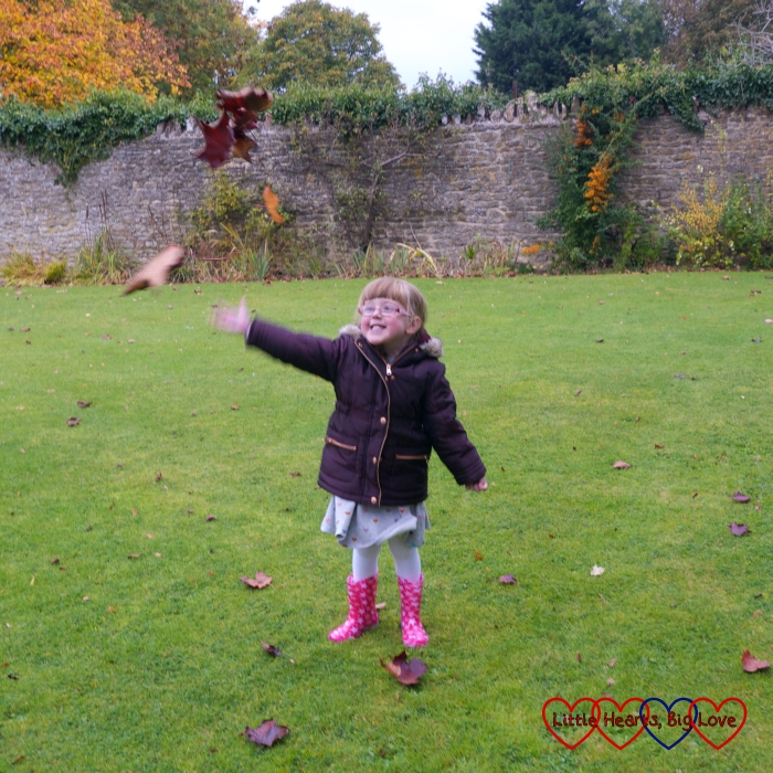 Jessica throwing leaves in the air