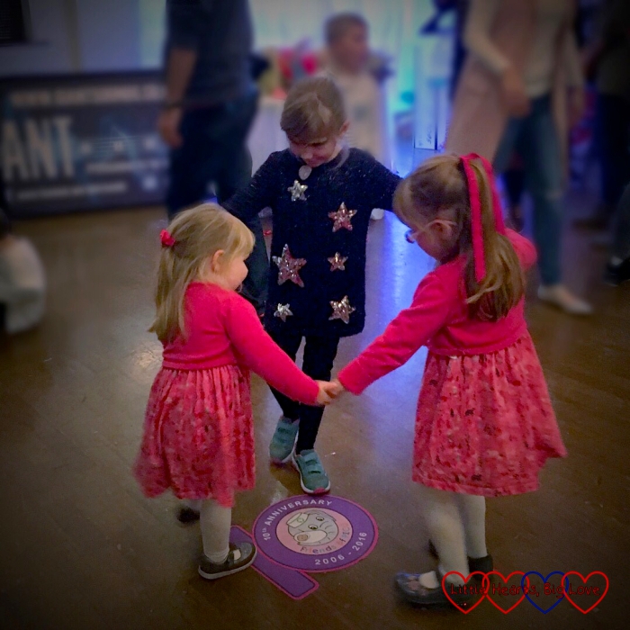 Jessica and Sophie dancing with their friend at the Friends of PICU 10th anniversary party