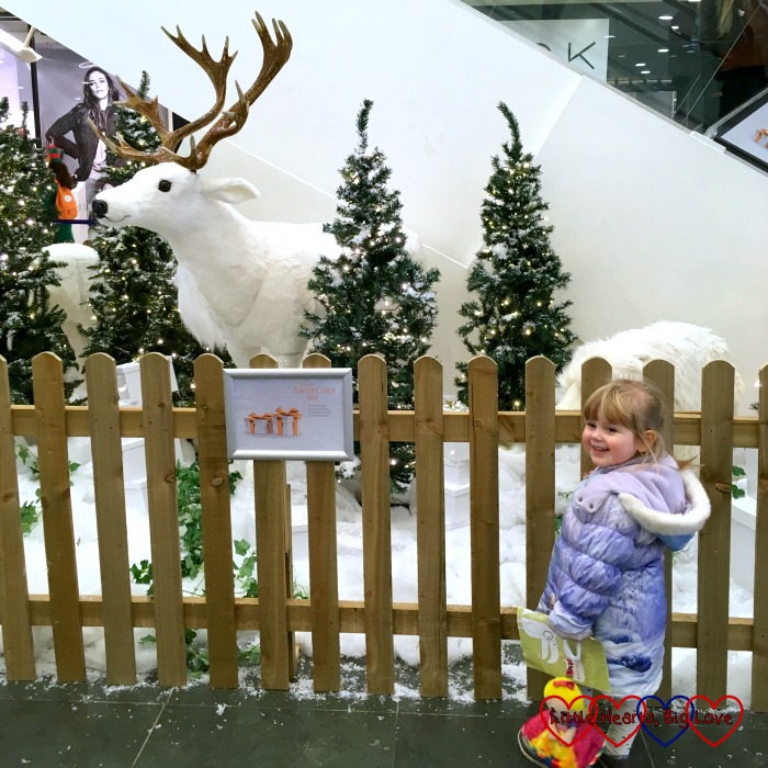 Sophie looking at the model of the reindeer and polar bear in the snow at the shopping centre