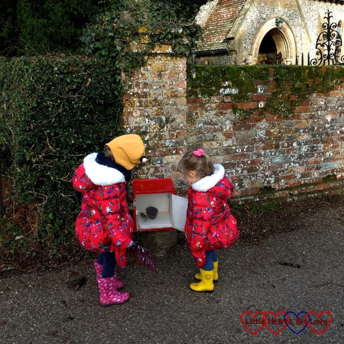 Sophie and Jessica opening one of the boxes next to the church at Hinton Ampner