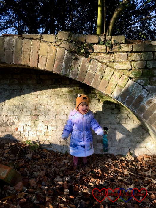 Sophie pretending to be a troll and roaring whilst standing under the bridge