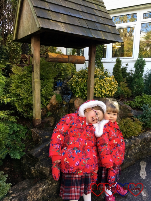 Jessica and Sophie standing by the wishing well at Babbacombe Model Village