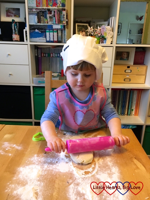 Sophie rolling out the scones whilst wearing her chef's hat