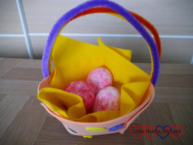 The finished Easter basket filled with pink glittery eggs