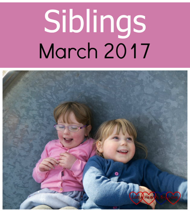 Jessica wearing a pink cardigan lying next to a grinning Sophie in a blue cardigan - Siblings: March 2017
