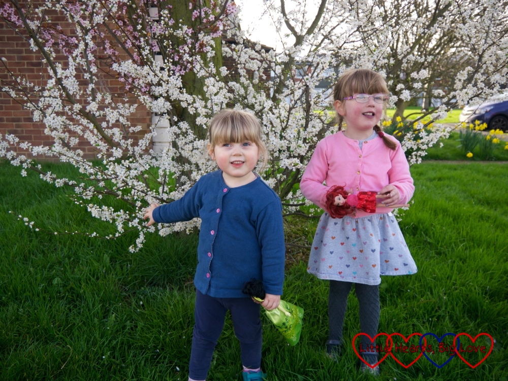 Sophie and Jessica standing in front of a blossom-covered tree
