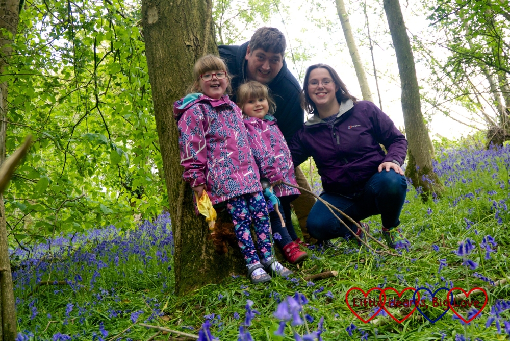 Jessica, Sophie, hubby and me standing by a tree surrounded by bluebells