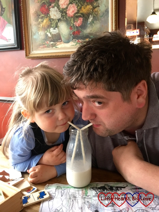 Sophie and her daddy sharing a milkshake