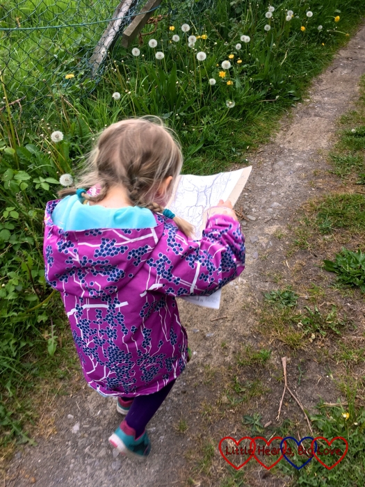 Sophie heading out on a walk holding the footpath map