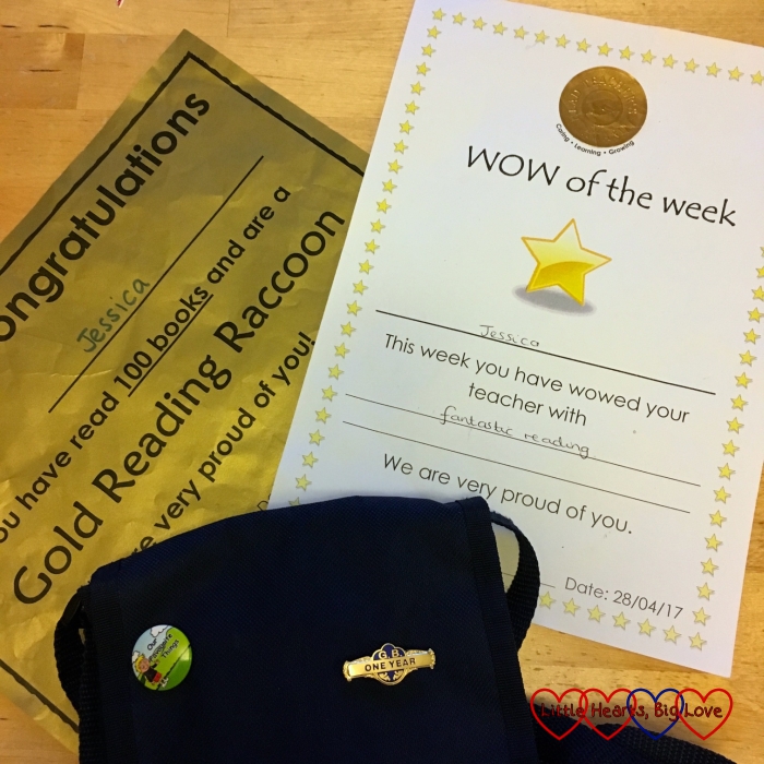 Jessica's gold reading raccoon certificate, WOW of the Week and 1 year badge on her Girls' Brigade badge bag