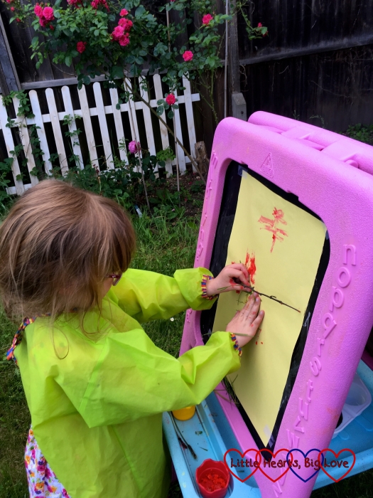 Jessica painting with a stick