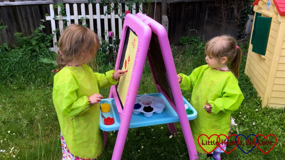 Jessica and Sophie painting outdoors in the garden