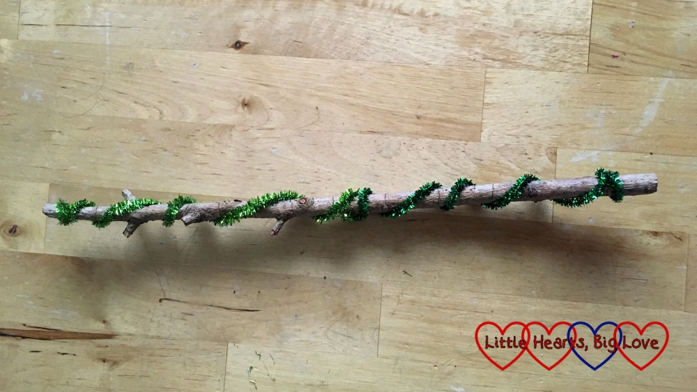 A stick with glittery pipe-cleaners wrapped around it
