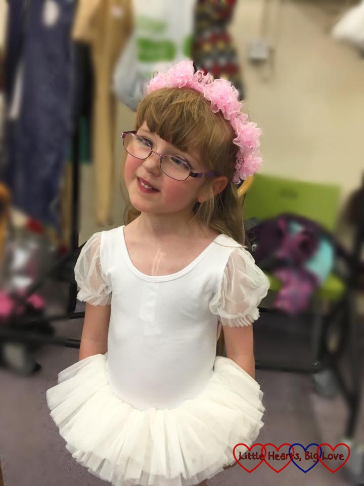 Jessica in a white tutu and pink flowers in her hair ready for the ballet show rehearsal