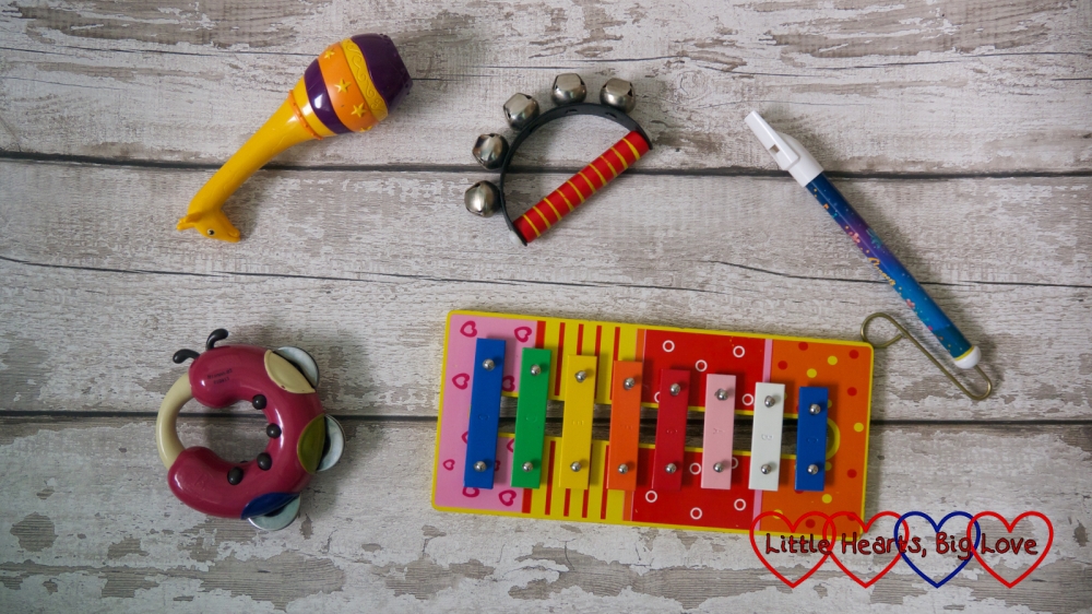 A selection of children's musical insturments - maracas, bells, slide whistle and a xylophone