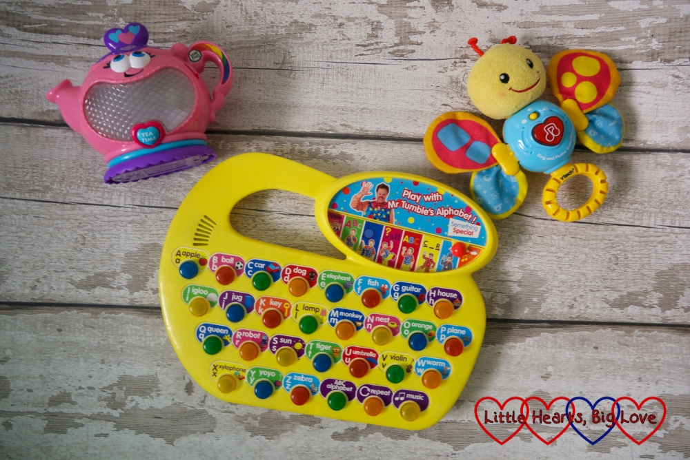 A selection of noisy toys - a talking teapot, talking butterfly and Mr Tumble's Alphabet