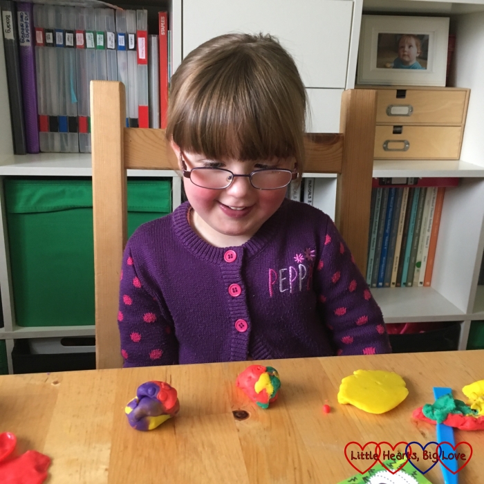 Jessica playing with Playdoh and mixing the colours up
