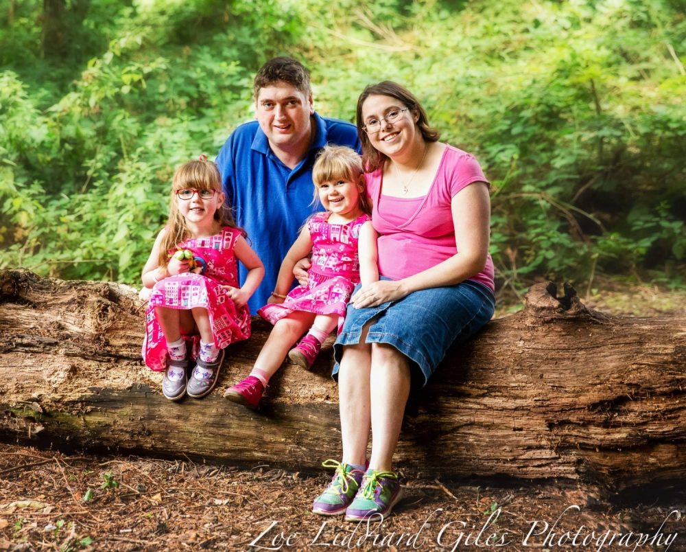 Me, hubby, Jessica and Sophie sitting on a log in Denham Country Park